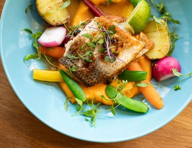 A plated salmon dish with herbs