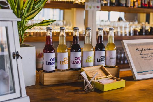 A vibrant display of flavored drinks on a wooden shelf