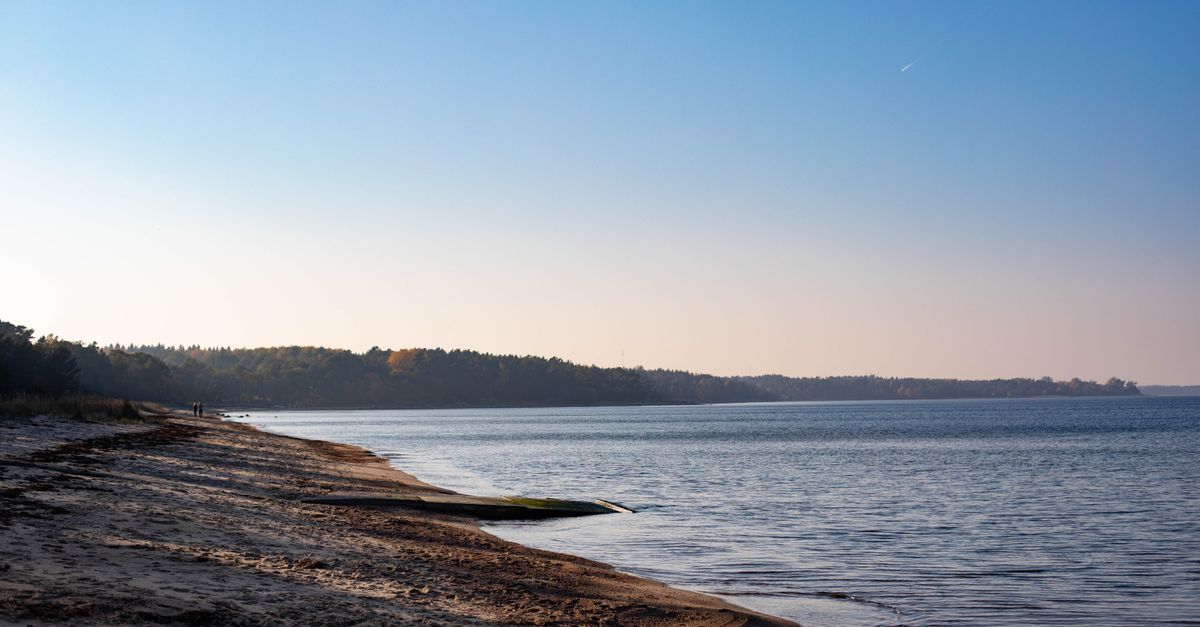 quiet coastal village with empty beach at sunrise, Europe