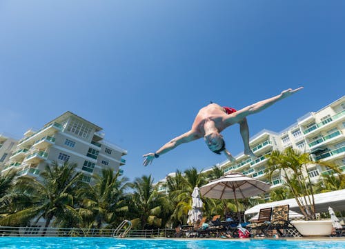 Free Man Jumping into a Pool  Stock Photo