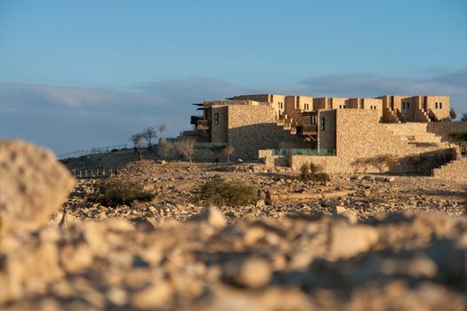Modern stone architecture of a luxury hotel in Israeli desert landscape.