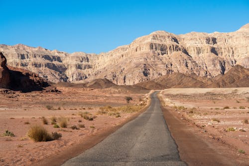 Empty Road Near Brown Rocky Mountain