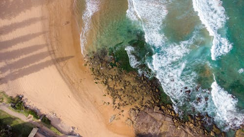 Aerial View of Waves Crashing on the Shore
