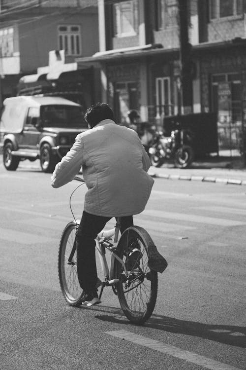 Back View of a Person on a Bicycle in City