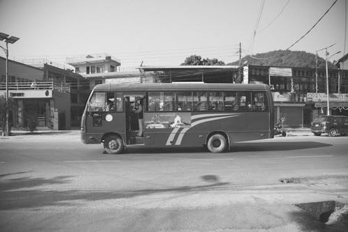 Grayscale Photo of Bus on the Road