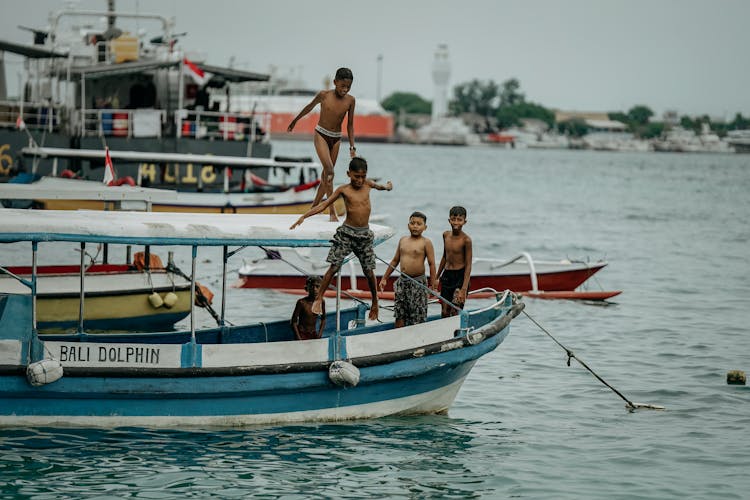 Boys Jumping Off Of A Boat