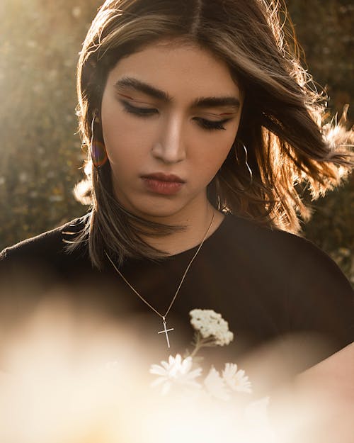 A woman with long hair holding flowers