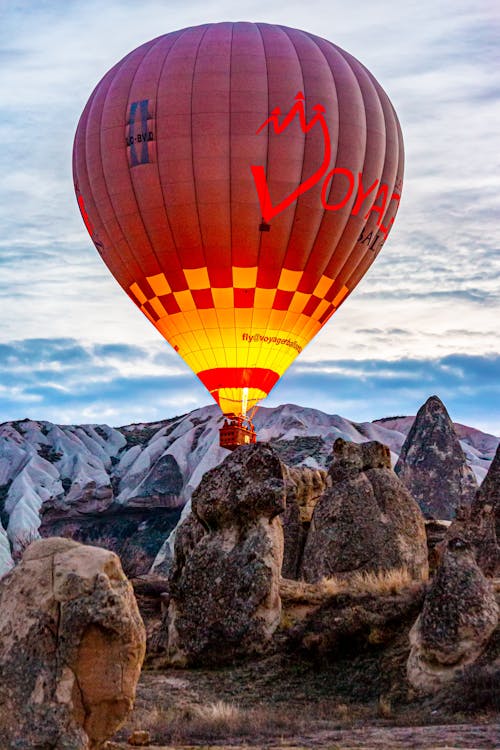 Hot Air Balloon Flying in Sky in Mountains Landscape