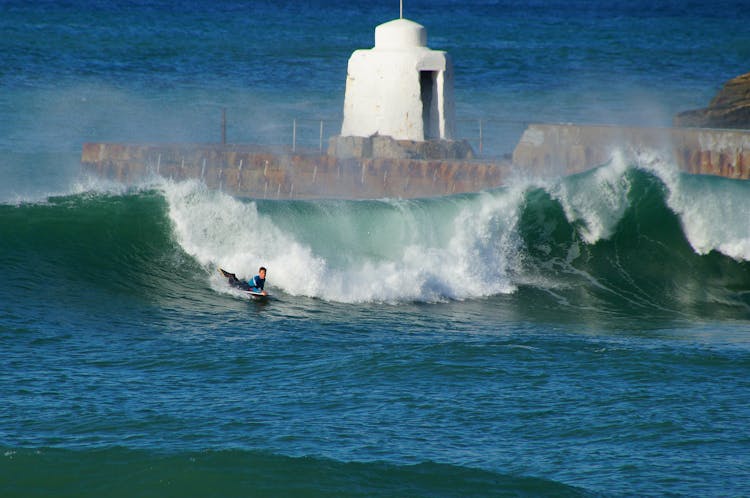 Man Surfing On The Ocean Waves