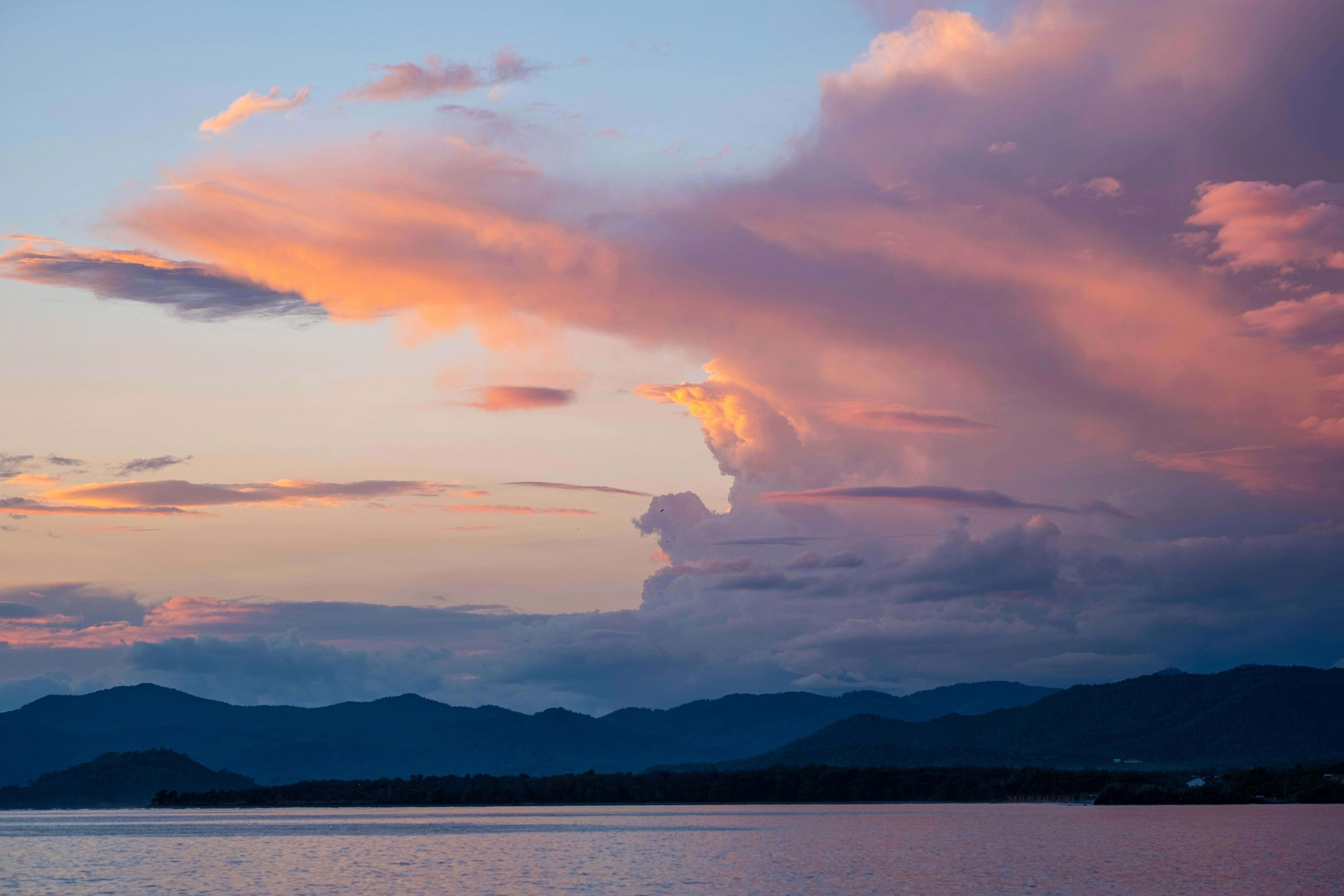 Clouds over Sea near Coast at Dusk Free Stock Photo