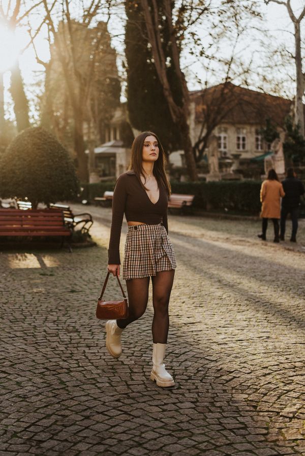 Woman in black blouse and checkered skirt