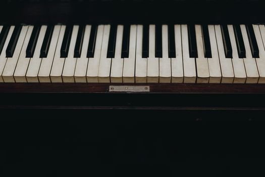 A close-up view of vintage piano keys showcasing the wear and character of the instrument.