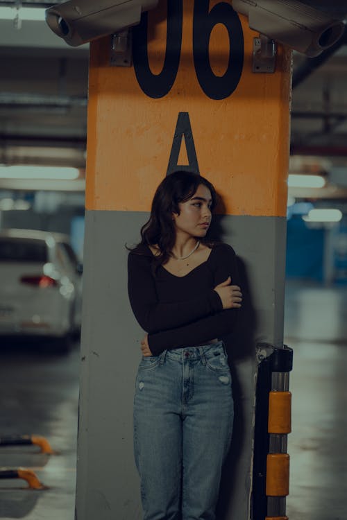 Woman Posing by Columns on Car Park