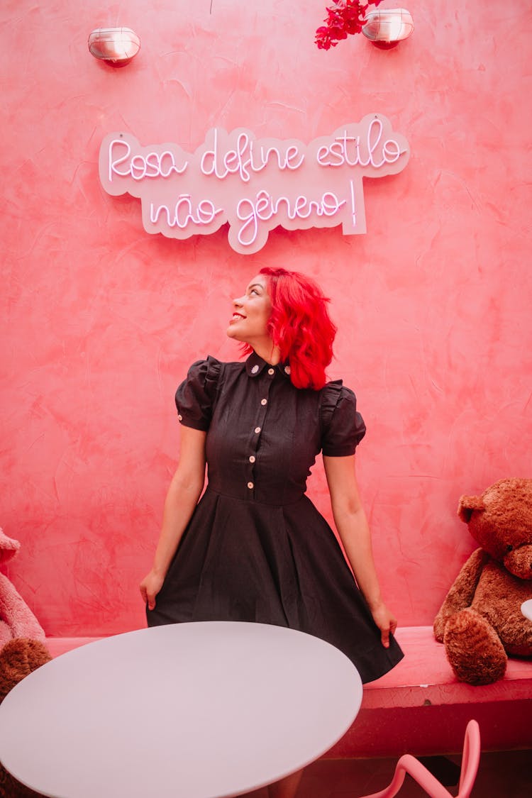 Woman Looking At Text On Pink Wall