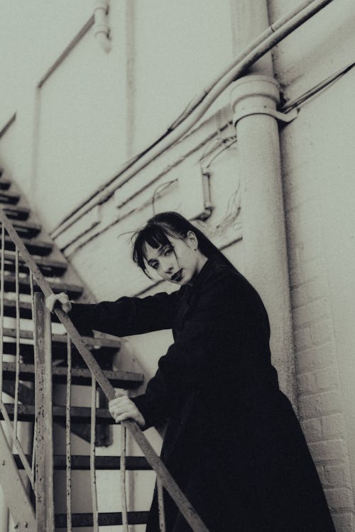 Portrait of a Pretty Girl Posing on a Staircase