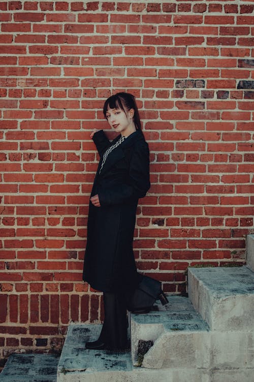 Woman in Black Coat Going Down on Stairs