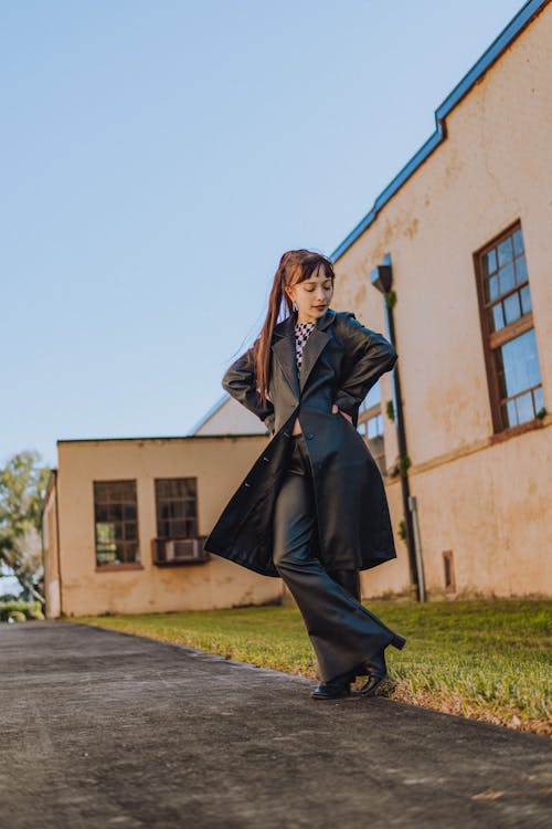 Young Fashionable Woman Standing in front of a Building in City 