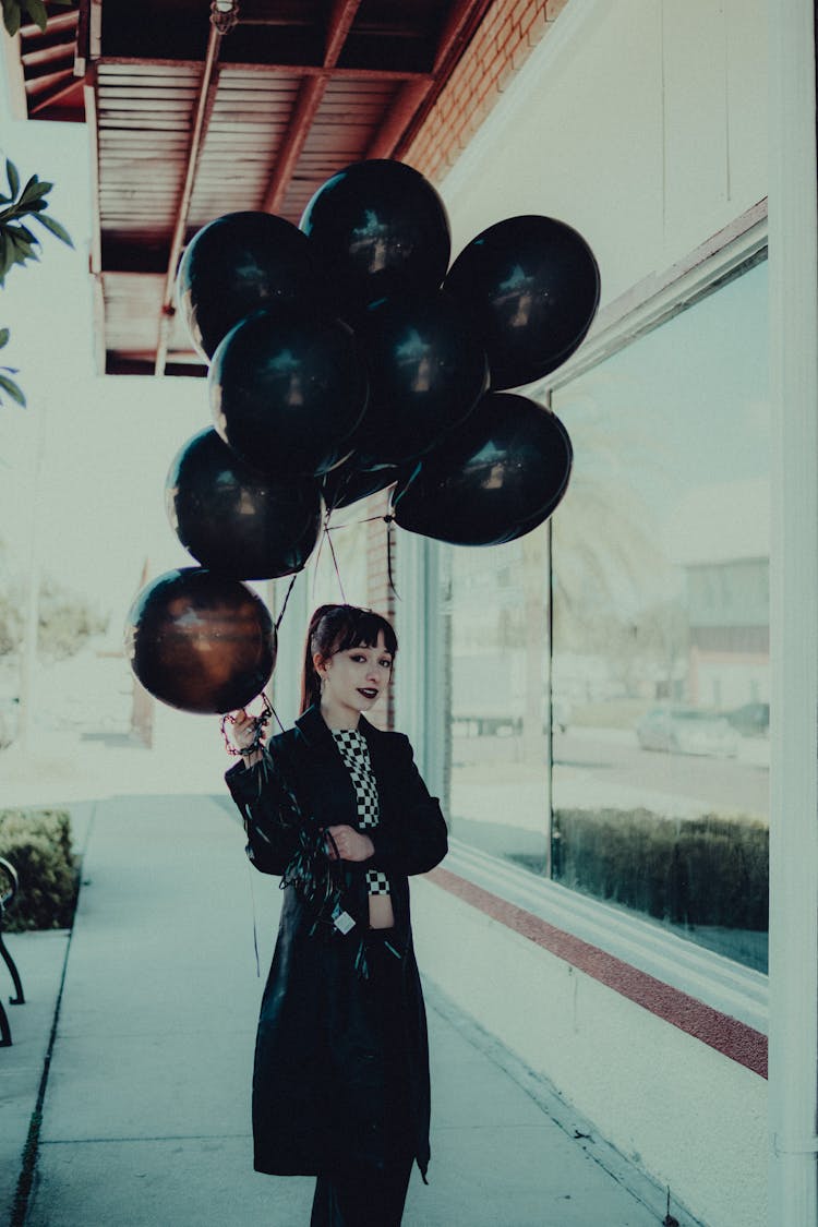 Photo Of Woman Holding Black Baloons