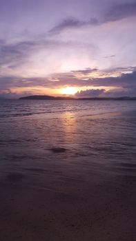 Beautiful sunset view from Ao Nang Beach in Thailand, capturing serene ocean waves and colorful skies.