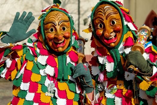 Vibrant wooden masked costumes at the Fasnacht festival in Freiburg, Germany.