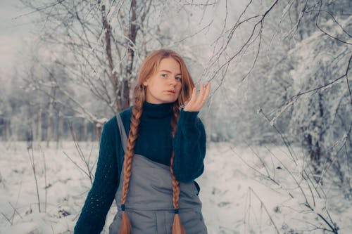 Portrait of a Redhead Wearing Long Braids Posing Outdoors in Winter