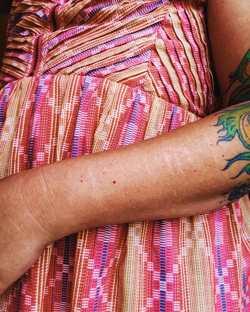 Arm with Tattoo on Colorful Fabric