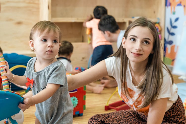 Woman With Baby Girl In Kindergarten