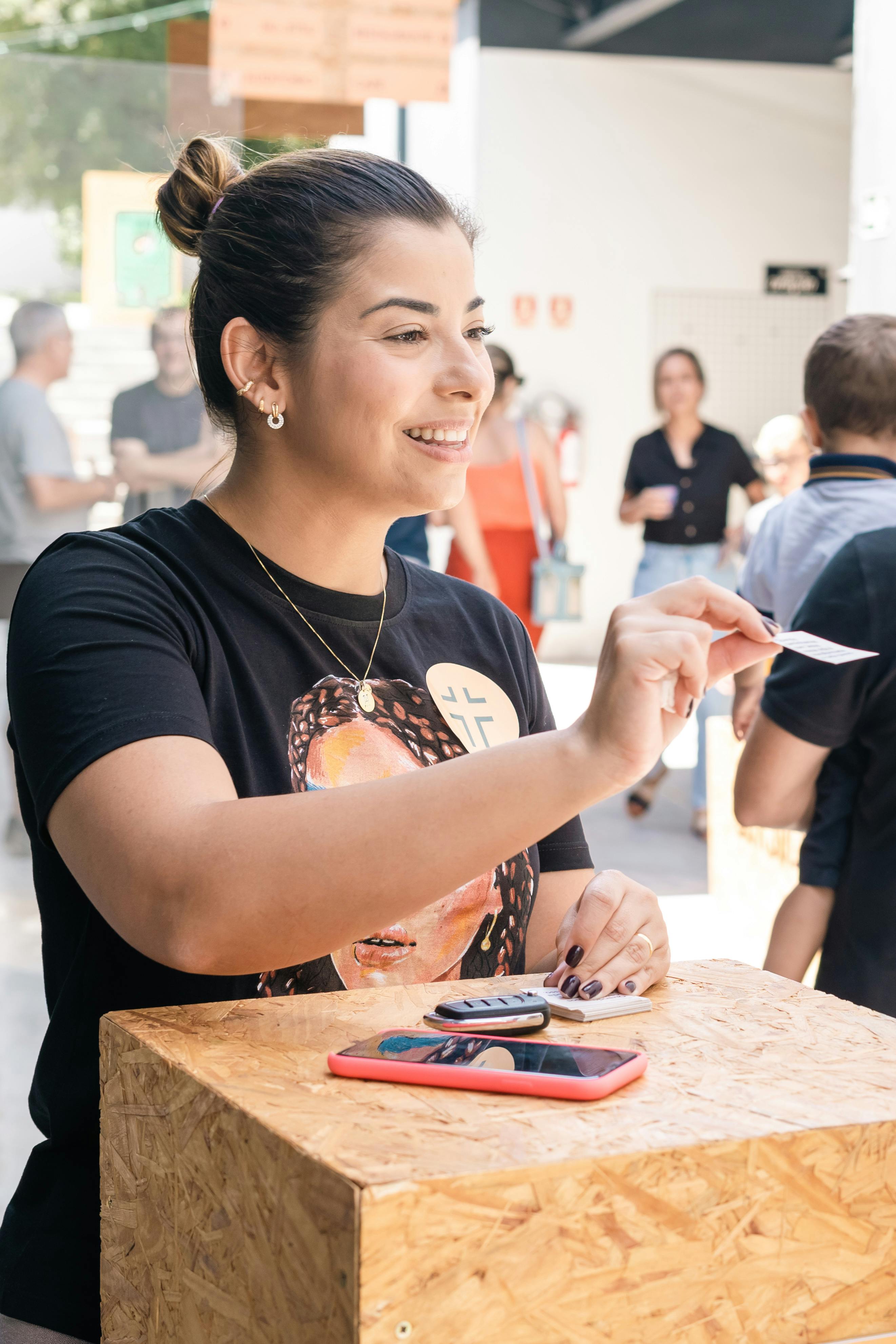 smiling woman distributing cards