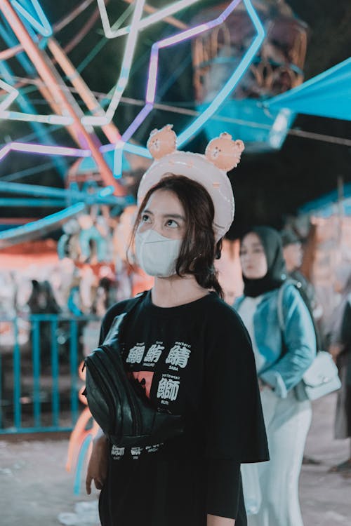 Girl in Black Shirt Wearing Face Mask at Amusement Park