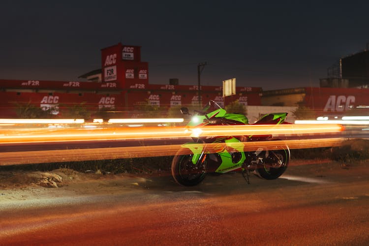 Green Kawasaki Ninja ZX-10R Motorcycle On The Road Behind The Factory In The Evening