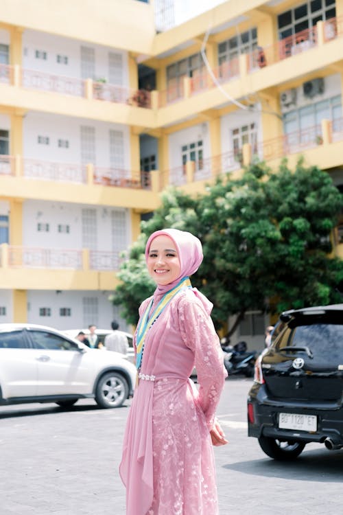 A Woman in Pink Dress Wearing Pink Hijab