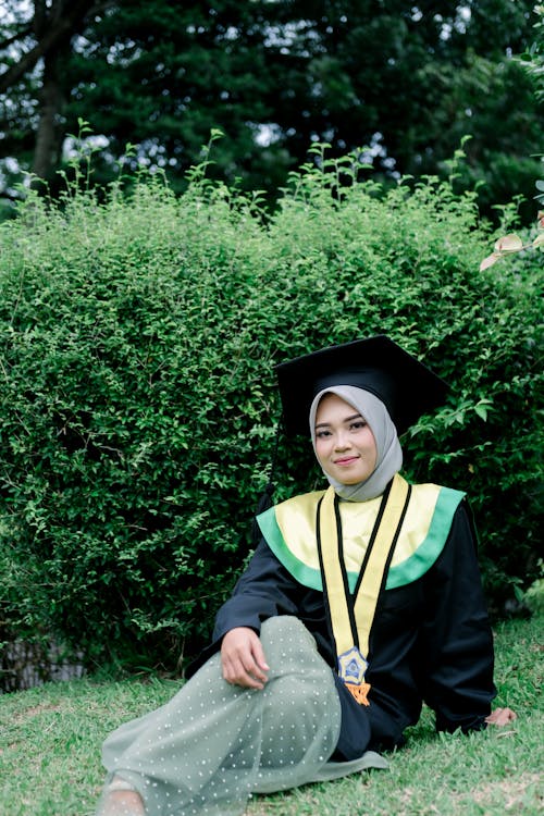 Smiling Woman in Academic Hat and with Medal