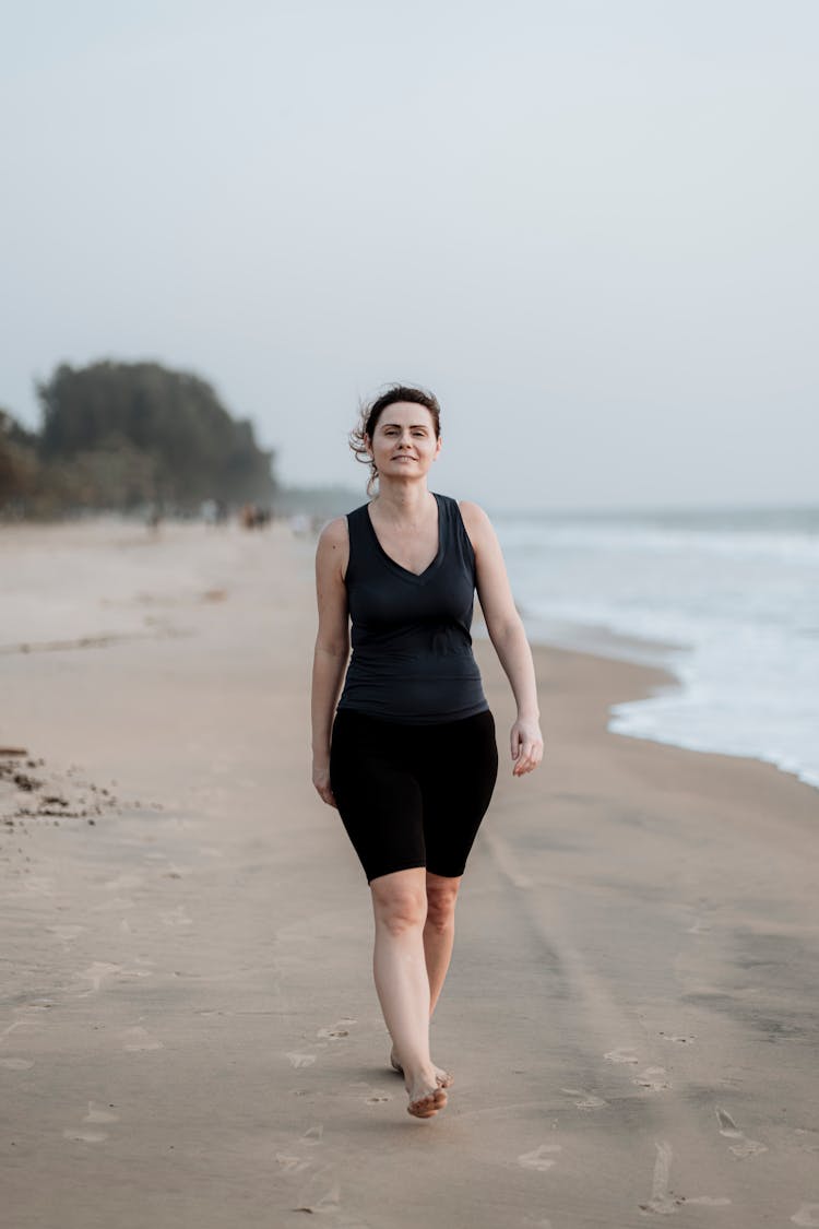 Woman Walking On The Beach 