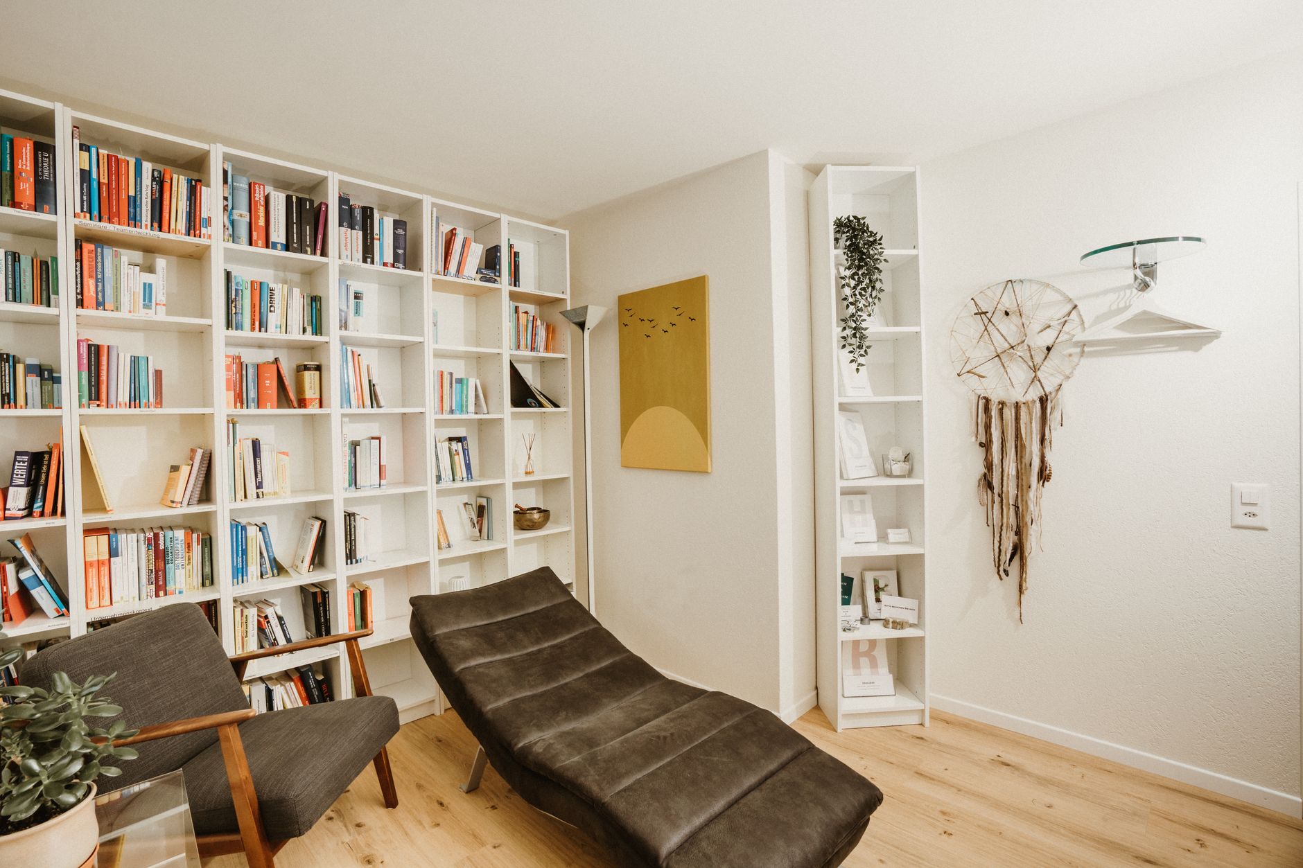 A serene and minimalist luxury psychological consulting office with floor-to-ceiling windows and high-end furnishings.