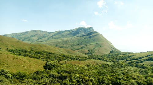 Free Landscape of Green Mountains under Blue Sky  Stock Photo