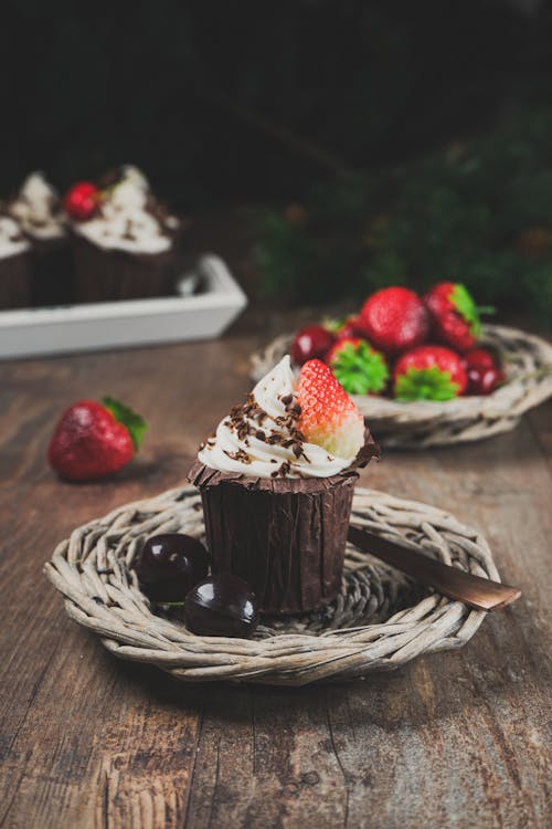 Close-up of a Chocolate Cupcake with Cream and Strawberries 