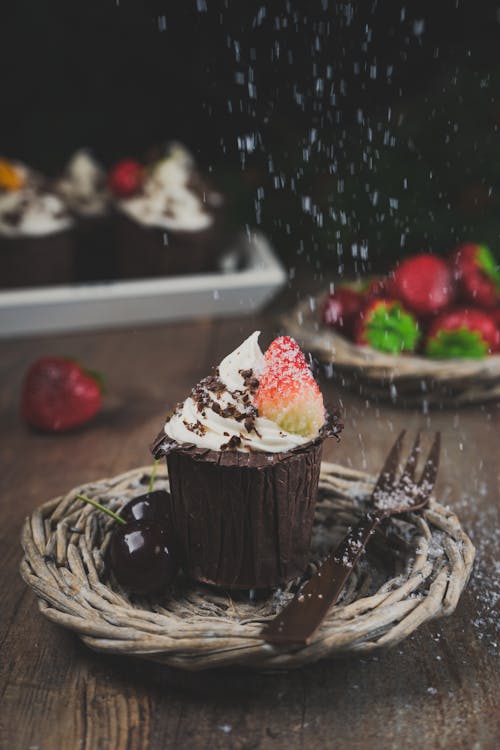 Free Chocolate Cupcake with Whipped Cream and a Strawberry  Stock Photo