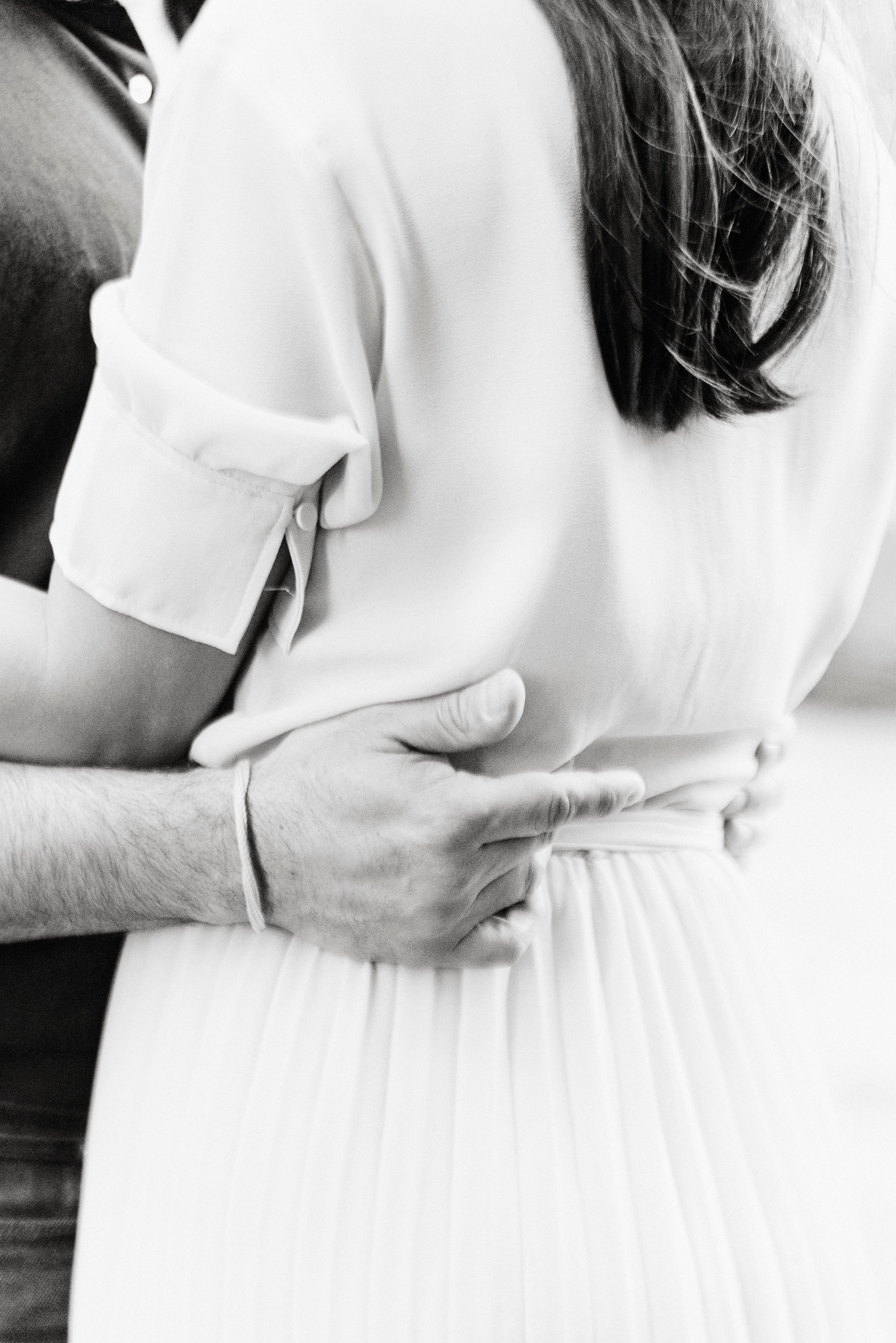 A couple embracing in a monochrome style, capturing a romantic moment.