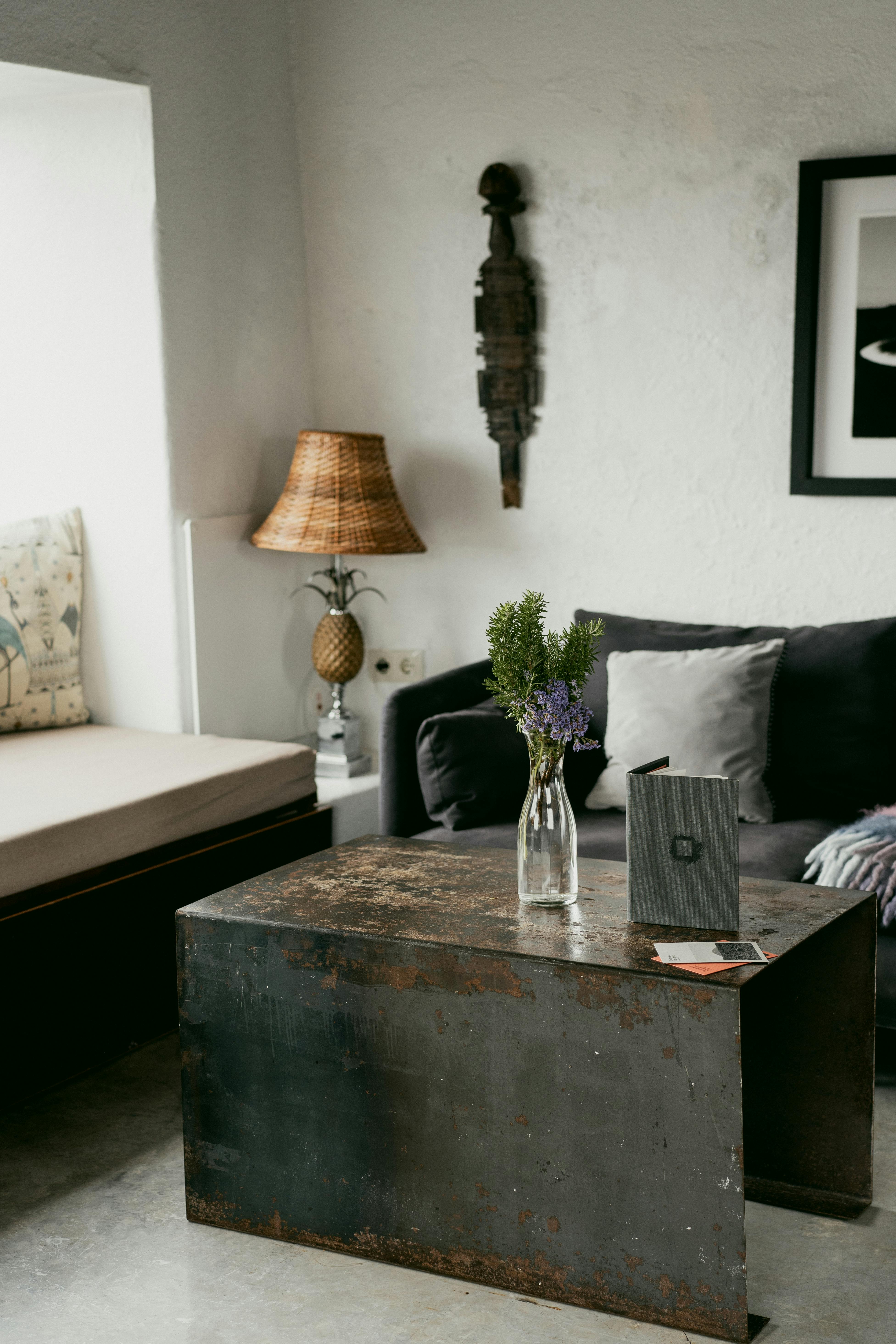 Free A cozy living room featuring a rustic coffee table, sofa, and decorative accents. Stock Photo