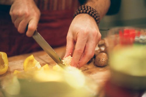 Person Slicing Yellow Bell Pepper