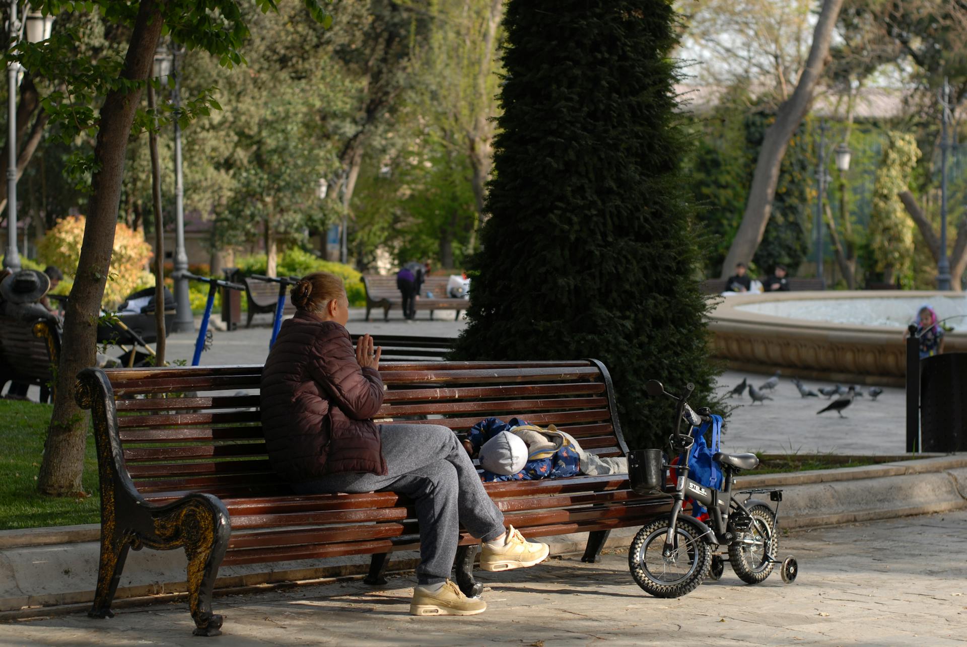 Grandmother with Child on Bench in Park