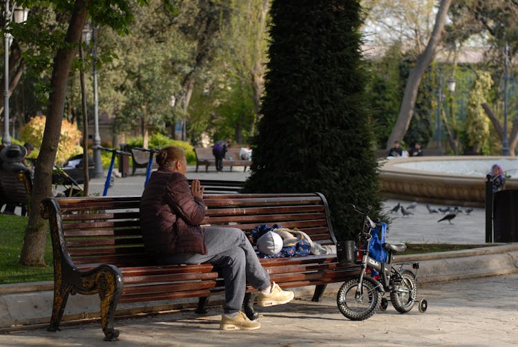 Grandmother With Child On Bench In Park