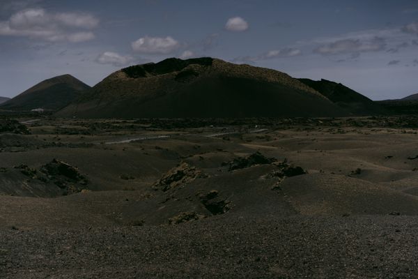 Dark volcanic landscape under a moody sky — photo by alleksana on Pexels