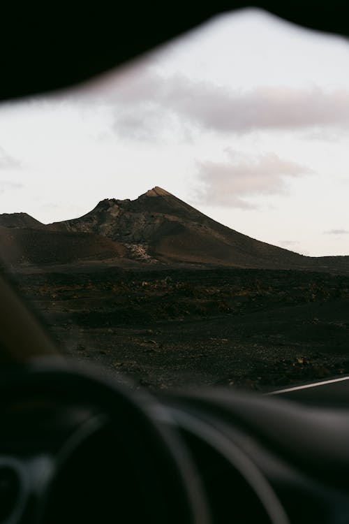 View on Mountain in Wild Landscape from Car Window