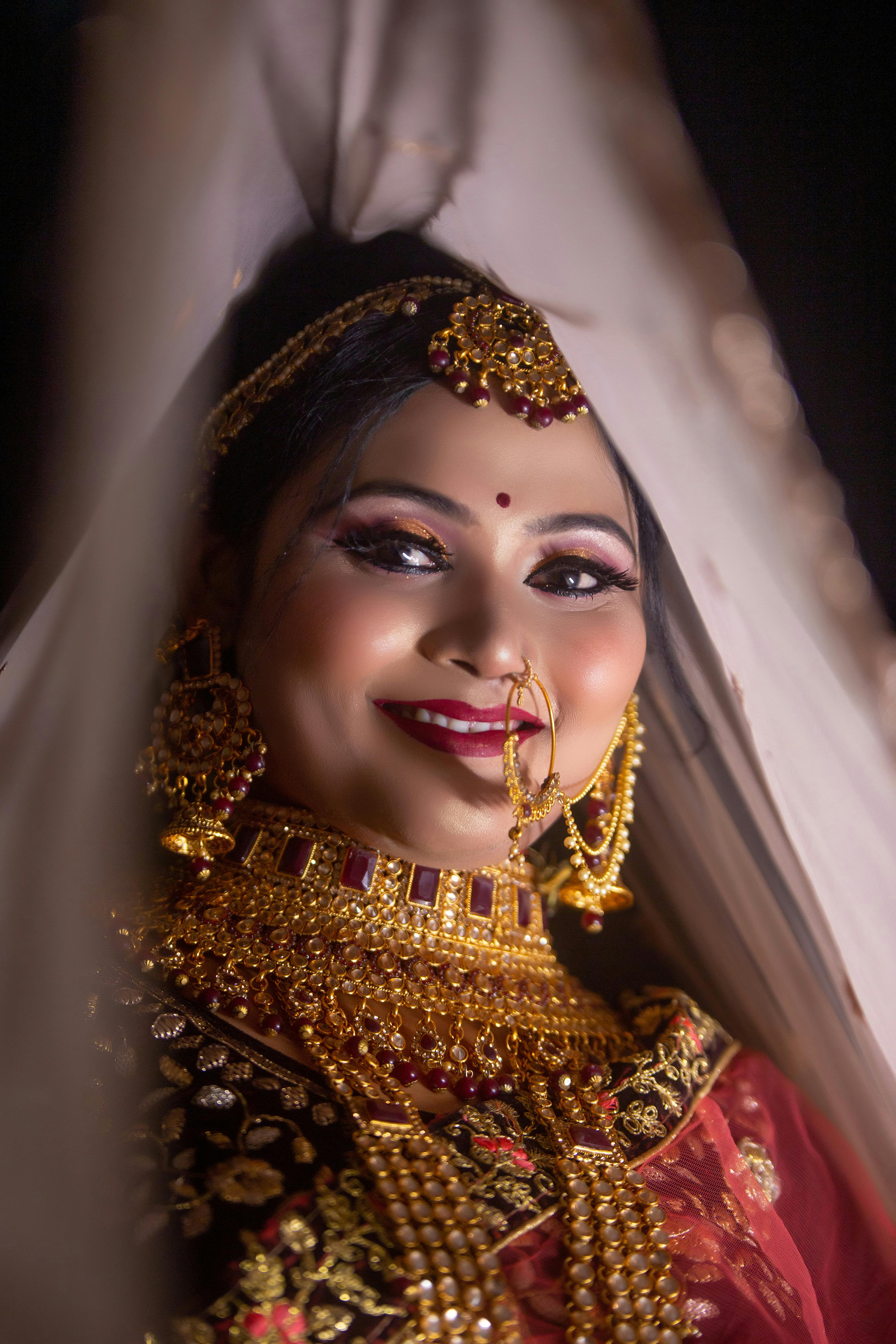 Stunning Indian bride in luxurious bridal costume with makeup and