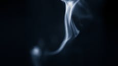Smoke on a black background with a blue background