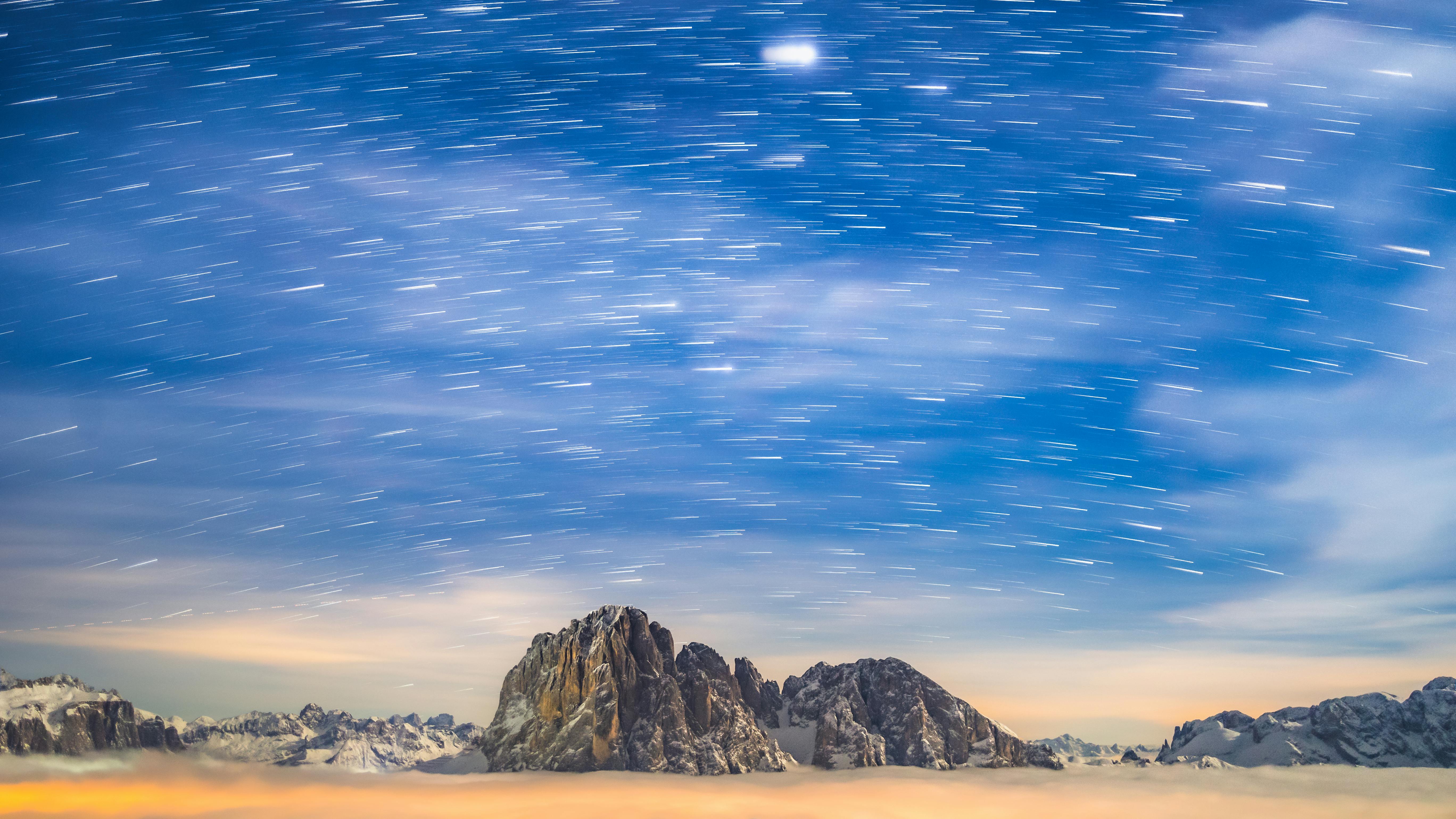 a-long-exposure-photograph-of-the-sky-above-a-mountain-range-free