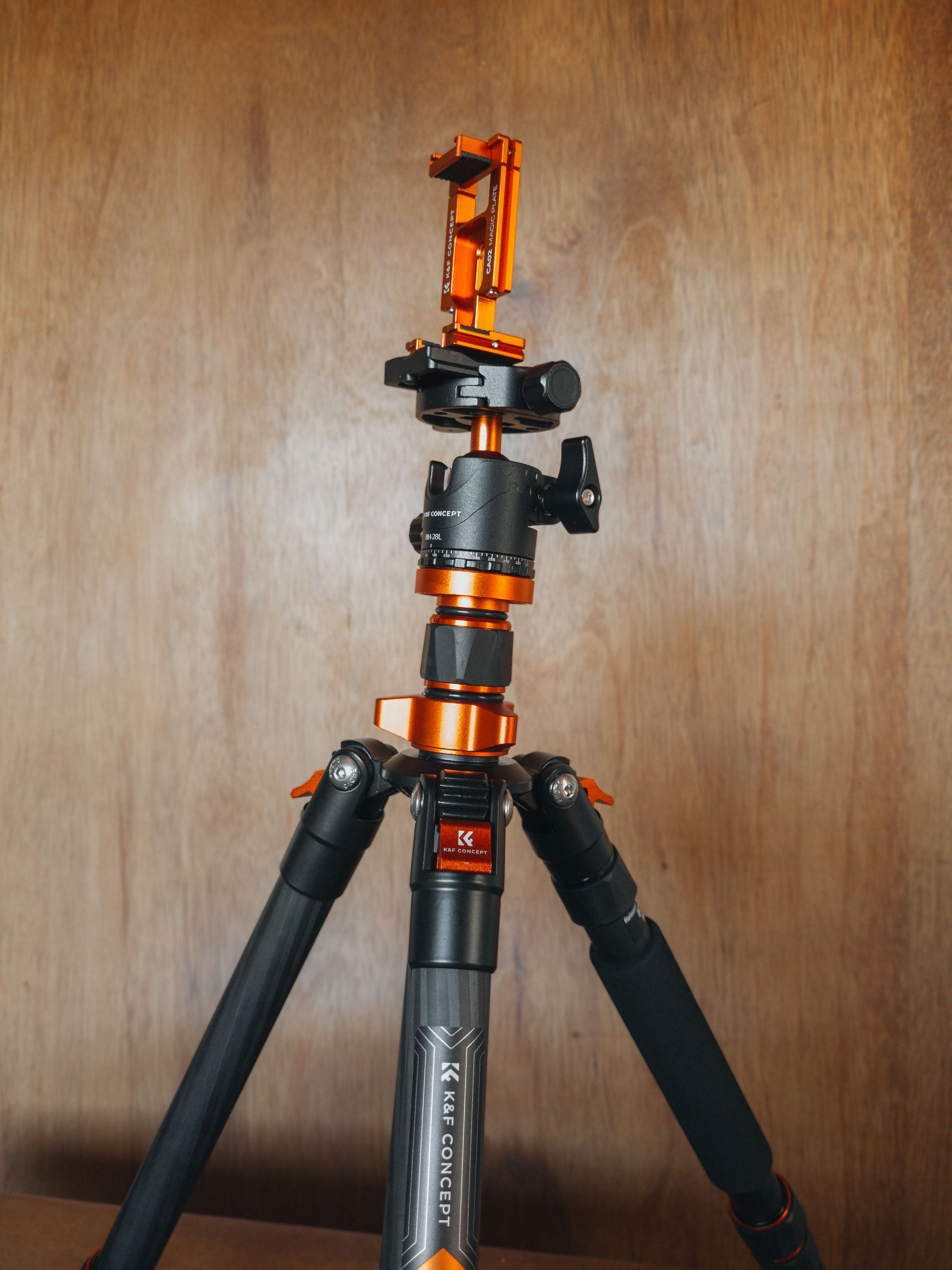A sleek professional tripod with orange accents, perfect for stable photography.