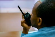 African man talking on a handheld radio device in Kigali, Rwanda.