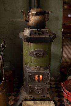Close-up of a vintage kettle on an antique stove, capturing rustic charm in a Turkish setting.